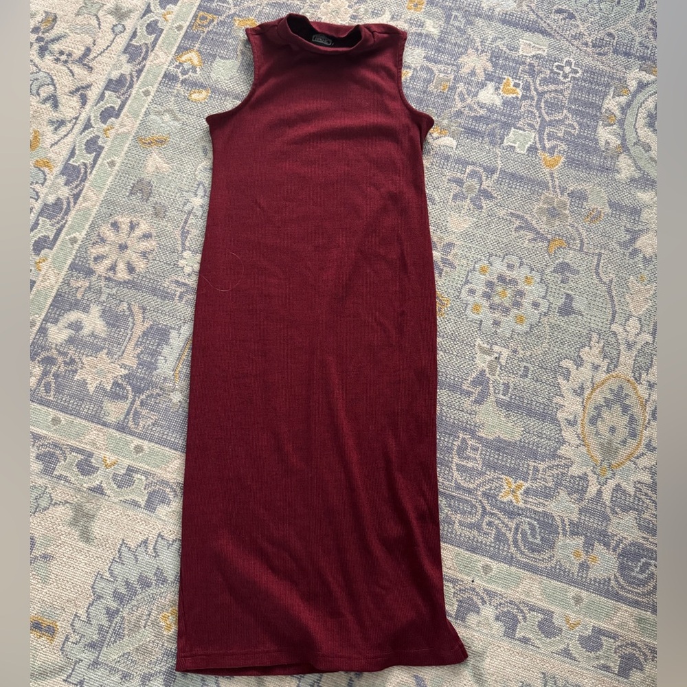 Ribbed sleeveless sweater dress. Button detail, shallow turtleneck.